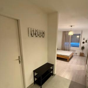 a living room with a bed and a table in a room at Appt Lausanne Gare - Totti in Lausanne +1 photo