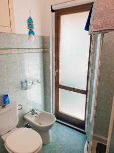 a bathroom with a toilet and a sink at Il Nido sullo Scoglio in Bonassola +38 photos