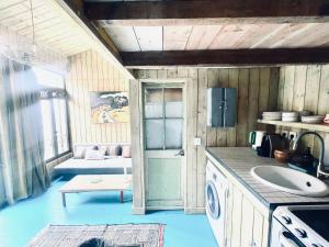 a kitchen with a sink and a couch in a room at Respiro in Paris