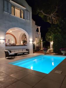 a swimming pool in a backyard at night at Villa Croce Anacapri in Anacapri