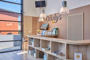 a restaurant with a counter with books on it at Appart'hôtel Odalys City - Antibes Olympe in Antibes