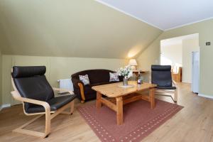 a living room with a table and two chairs at Dorfstraße 28 Seerose in Klausdorf