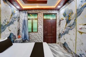 a room with a door and a bed in it at Hotel O Royal Prayag in Prayagraj