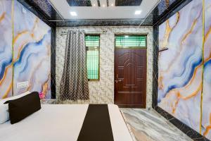 a room with a bed and a door at Hotel O Royal Prayag in Prayagraj
