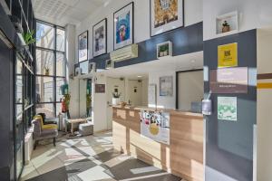 a lobby of a store with a counter and chairs at Appart'hôtel Odalys City - Monaco Les Hauts de la Principauté in Beausoleil