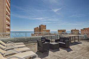 a balcony with chairs and a view of the city at Appart'hôtel Odalys City - Monaco Les Hauts de la Principauté in Beausoleil