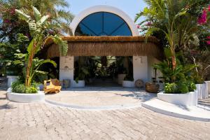 a building with a courtyard with palm trees at Deluxe Rooms Pet Friendly in Fethiye