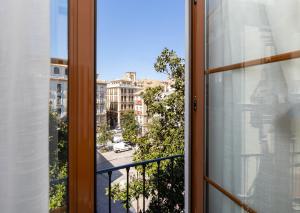 a window with a view of a city at Nest Style Granada in Granada