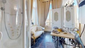 a bathroom with a sink and a shower and a couch at Château de Beaucamp - Castel des anges in Wailly-Beaucamp +48 photos