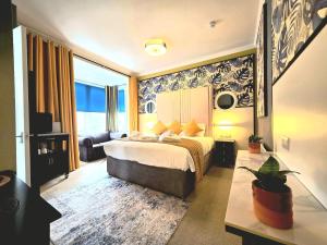 a hotel room with a bed and a large window at Yardley Manor Hotel in Torquay