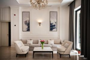 a living room with a couch and two chairs and a table at Hotel Moskva in Budva