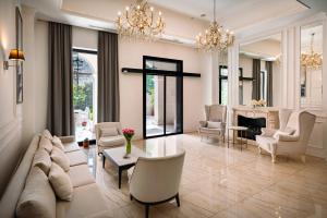 a living room with a couch and chairs and a fireplace at Hotel Moskva in Budva