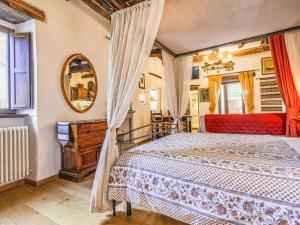 a bedroom with a bed and a mirror at Apartment Maghinardo by Interhome in Palazzuolo sul Senio