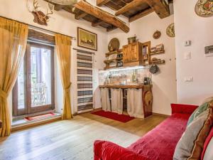 a living room with a red couch and a window at Apartment Maghinardo by Interhome in Palazzuolo sul Senio