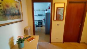 a living room with a table and a kitchen at BILOCALE IN PIAZZA A NUMANA VISTA MARE BELLISSIMA - cod 485 in Numana