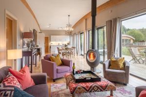 a living room with a couch and chairs and a fireplace at Charlie in Richmond
