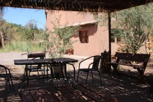 a table and chairs in front of a house at Casa Garces in San Pedro de Atacama