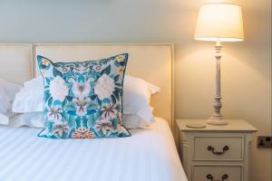 a bed with a blue pillow next to a lamp at Finley in Richmond