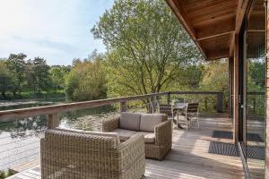 a deck with wicker chairs and a table and chairs on a house at Finley in Richmond