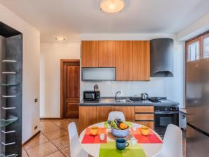a kitchen with a table and chairs in a room at Apartment Casa Luvit by Interhome in Menaggio