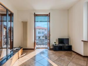 an empty living room with a view of a building at Apartment Casa Luvit by Interhome in Menaggio