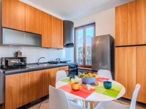 a kitchen with a table with a bowl of fruit on it at Apartment Casa Luvit by Interhome in Menaggio