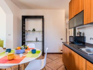a kitchen with a table with a bowl of fruit on it at Apartment Casa Luvit by Interhome in Menaggio +17 photos