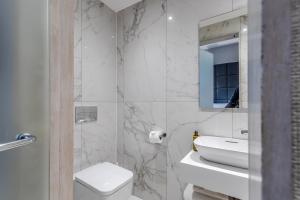 a bathroom with a toilet and a sink and a mirror at The Inn on the Mile in Edinburgh +46 photos