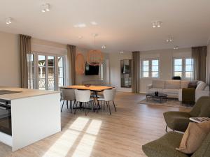 a kitchen and living room with a table and chairs at Alte Wassermühle Nord in Börm