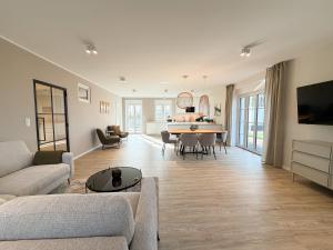 a living room with a couch and a table at Alte Wassermühle Nord in Börm
