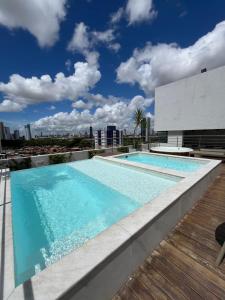 a swimming pool on the roof of a building at Flat Manaira in João Pessoa