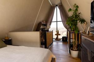a bedroom with a bed and a large window at Widok Paleśnica in Paleśnica