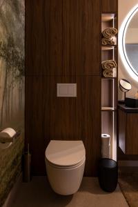 a bathroom with a white toilet in a wooden wall at Widok Paleśnica in Paleśnica +60 photos