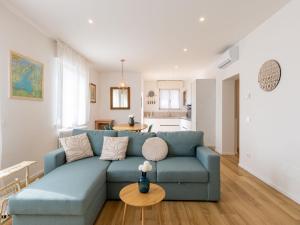 a living room with a blue couch and a table at Apartment Lago di Luce by Interhome in Riva del Garda