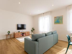 a living room with a couch and a tv at Apartment Lago di Luce by Interhome in Riva del Garda +30 photos