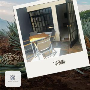 a picture of a table and chairs in front of a house at Casa Morelos Tekilán in Tequila