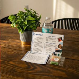 a table with a plant and a bottle of water at Casa Morelos Tekilán in Tequila +2 photos
