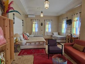a living room with a bed and a couch at Kasbah Ntifa in Ouzoud