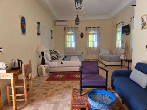 a living room with a bed and a couch at Kasbah Ntifa in Ouzoud +43 photos