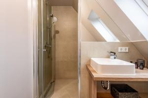 a bathroom with a sink and a shower at Princessa Coast in Süderende +45 photos