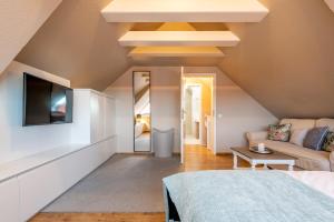 a living room with a bed and a couch at Princessa Coast in Süderende