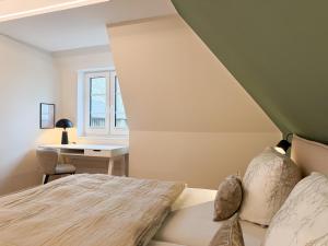a bedroom with a bed and a desk at Alte Wassermühle Süd in Börm