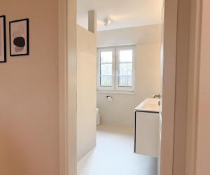 a white bathroom with a sink and a window at Alte Wassermühle Süd in Börm +39 photos
