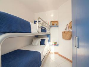 a bedroom with a bunk bed with blue and white at Apartment Mare 8 by Interhome in Porto Cervo