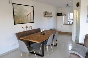a dining room with a wooden table and chairs at Seeluft in Warin