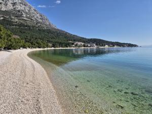 a beach with clear water and a rocky shore at Studio Rilić-1 by Interhome in Zaostrog
