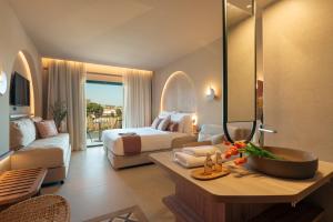 a hotel room with a bed and a bathroom at Zeus Eleva Kassandra Lagoon in Hanioti