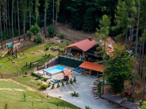 an aerial view of a house with a pool and a playground at Chalet Pine Hill by Interhome in Klenovnik