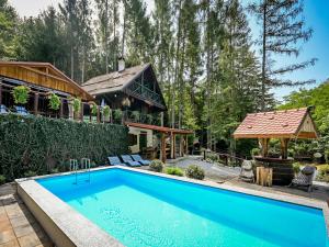 a house with a swimming pool in front of a house at Chalet Pine Hill by Interhome in Klenovnik