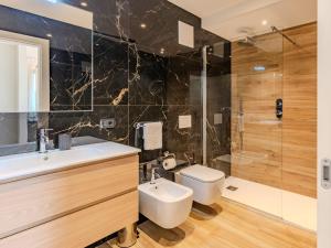 a bathroom with a sink and a toilet and a shower at Apartment Garda Oasis by Interhome in Riva del Garda
